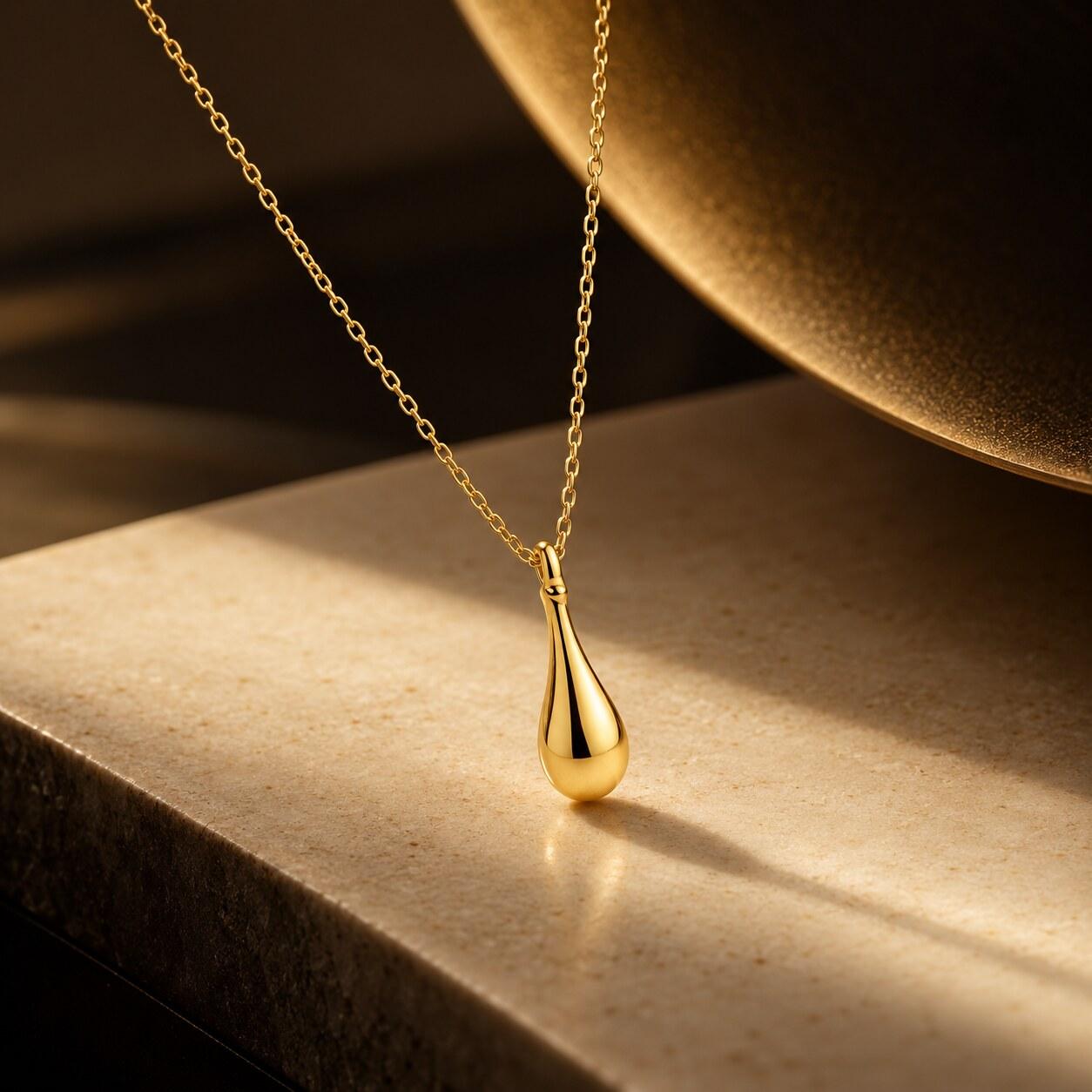An Armarium gold teardrop pendant